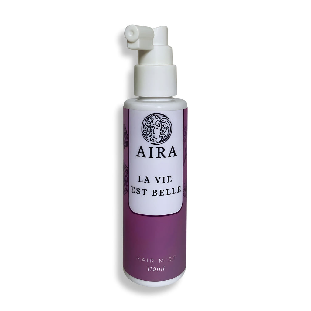 Aira hair mist bottle with a white pump on a white background