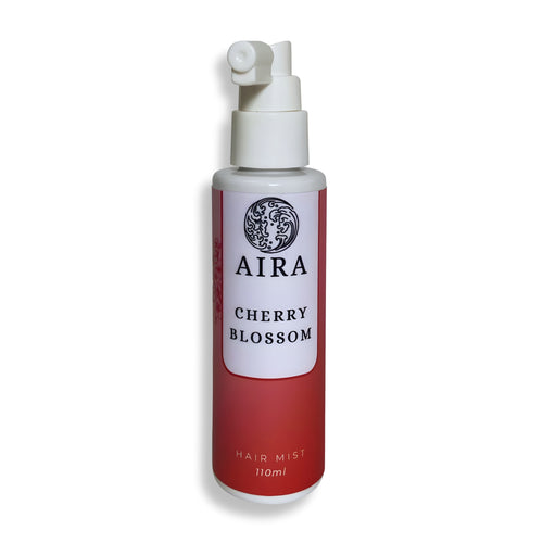 Red and white hair mist bottle labeled 'AIRA Cherry Blossom' on a white background