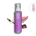 Purple bottle of AIRA Pink Fluff body splash with vanilla, berries, and cake illustration on a white background