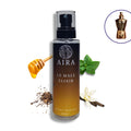 Aira Le Male Elixir body splash bottle with honey, mint, and vanilla elements on a white background
