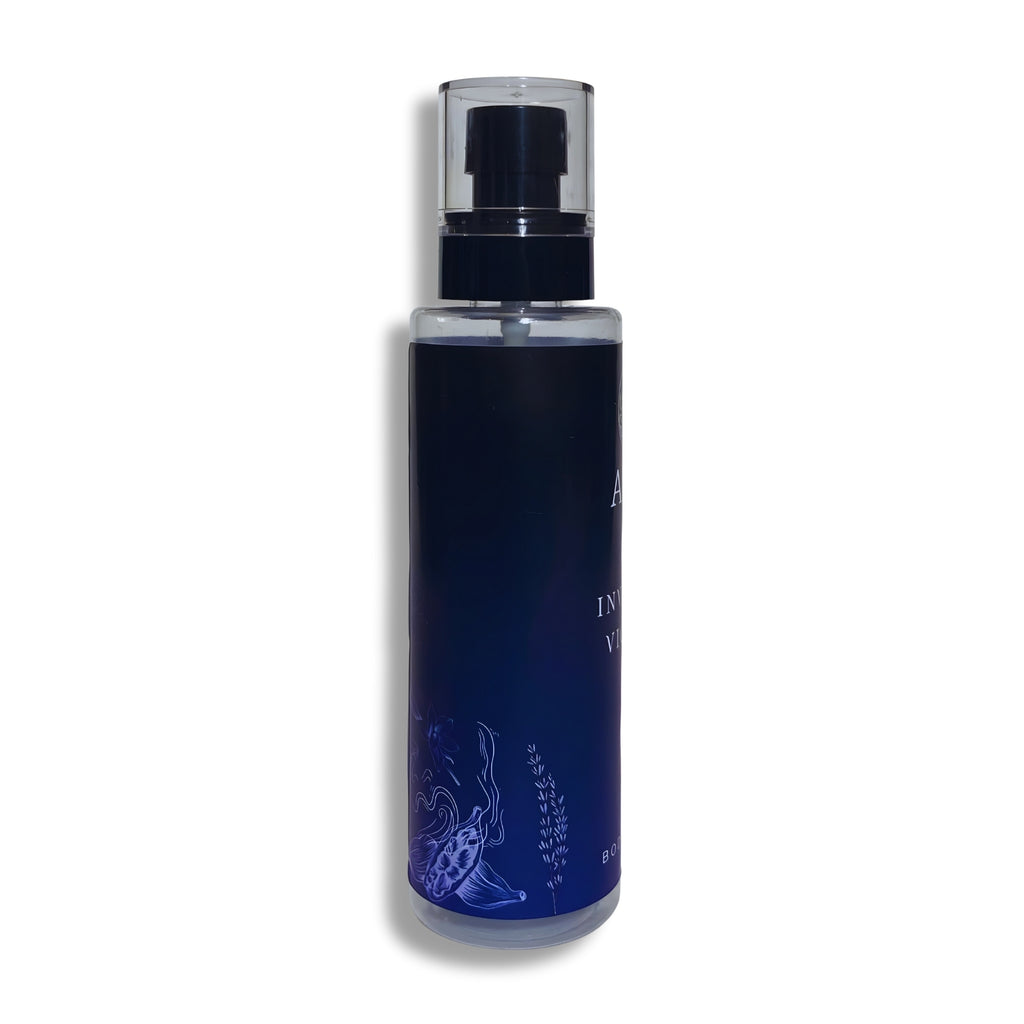 Blue body splash bottle with black cap on a white background