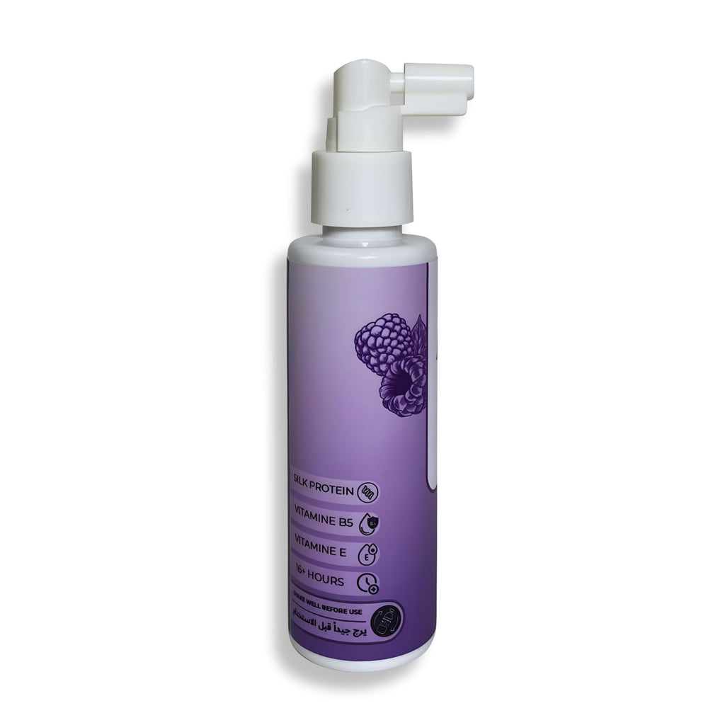 Purple spray bottle with a white pump on a white background